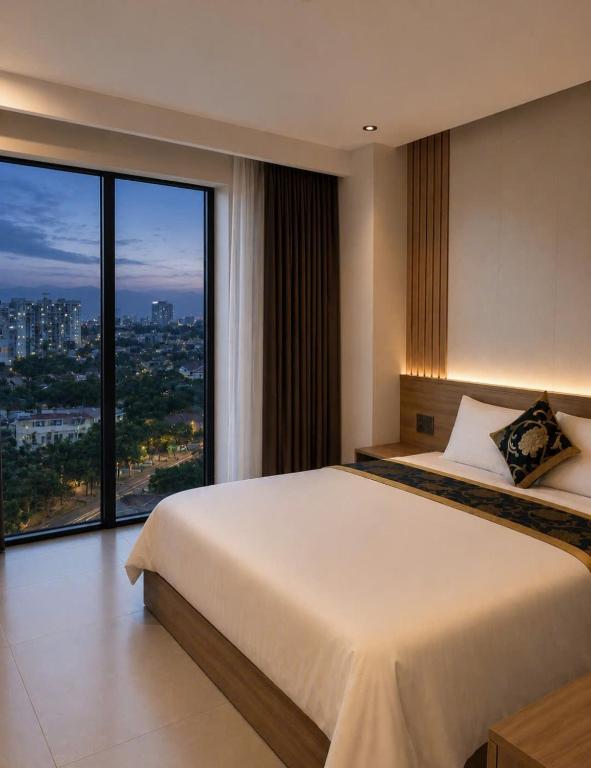 a bedroom with a large bed and a large window at An Bình Luxury Hotel in Bắc Giang