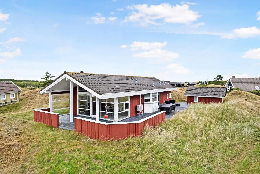 a house on top of a grassy hill at Holiday House On Fanø Near The Sea in Fanø