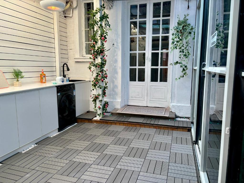 a porch with a door with flowers on it at Duplex Garden Villa with Private Courtyard Jing'an Villa Near Metro Downtown Shanghai in Shanghai