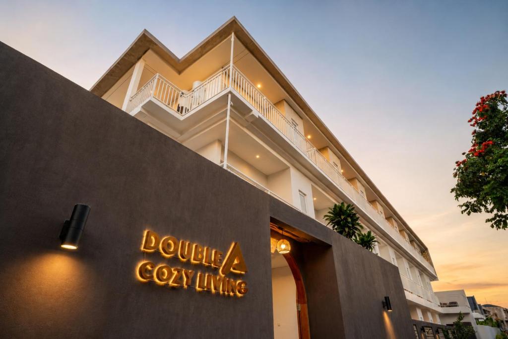 a building with a sign on the side of it at Double A Cozy Living in Canggu