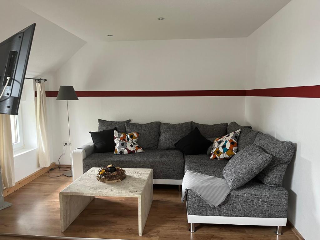 a living room with a couch and a table at Auszeit im Hunsrück in Braunshorn