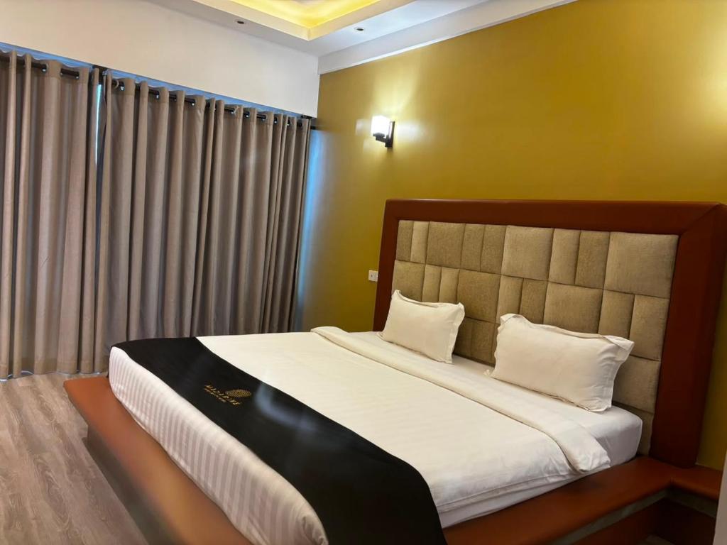 a bedroom with a large bed with white pillows at Mazarin Hiriketiya in Dickwella