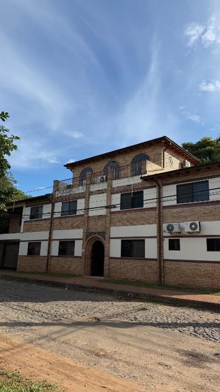 a large brick building with an open door at Pousada Akros in Asunción