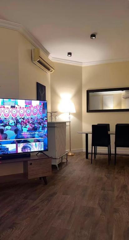 a living room with a large flat screen tv at darnas in Jeddah