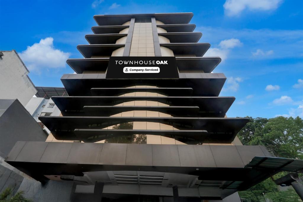 a building with a sign on the side of it at Townhouse Oak Ramdaspeth Downtown in Nagpur