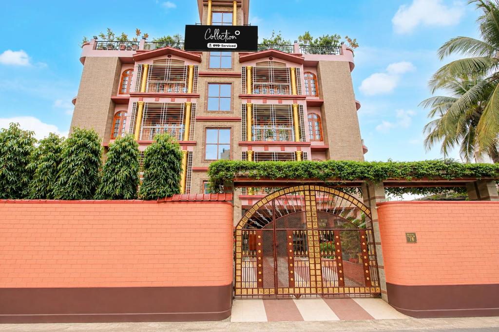 a building with a gate in front of it at Collection O Downtown Hospital Guwahati Formerly Cherry City Cottage in Guwahati