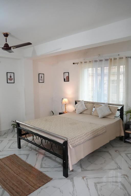 a bedroom with a large bed in a room at Retreat Homes in Siliguri