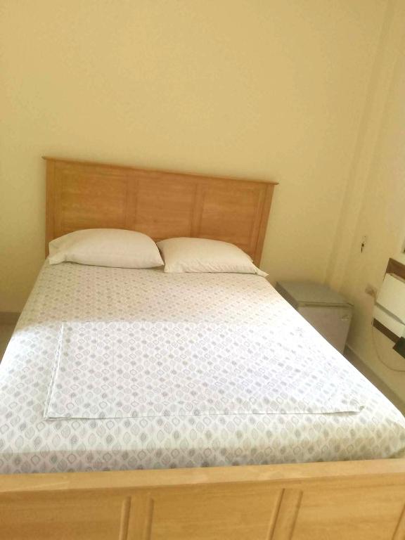 a bed with two pillows on it in a bedroom at Gemini Hotel & Restaurant in Libaong