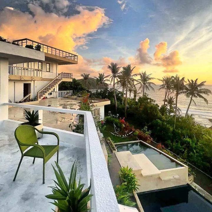 a balcony of a house with a swimming pool at Alon stay in Baras