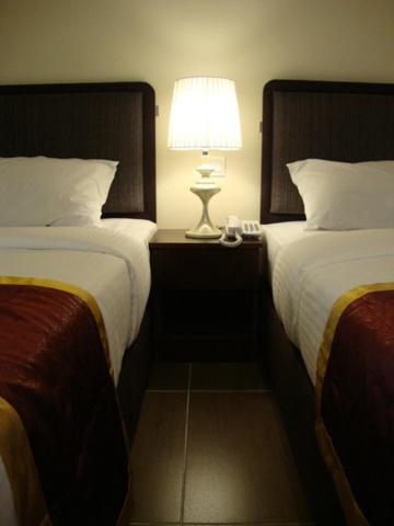 Postel nebo postele na pokoji v ubytování DM Hotel