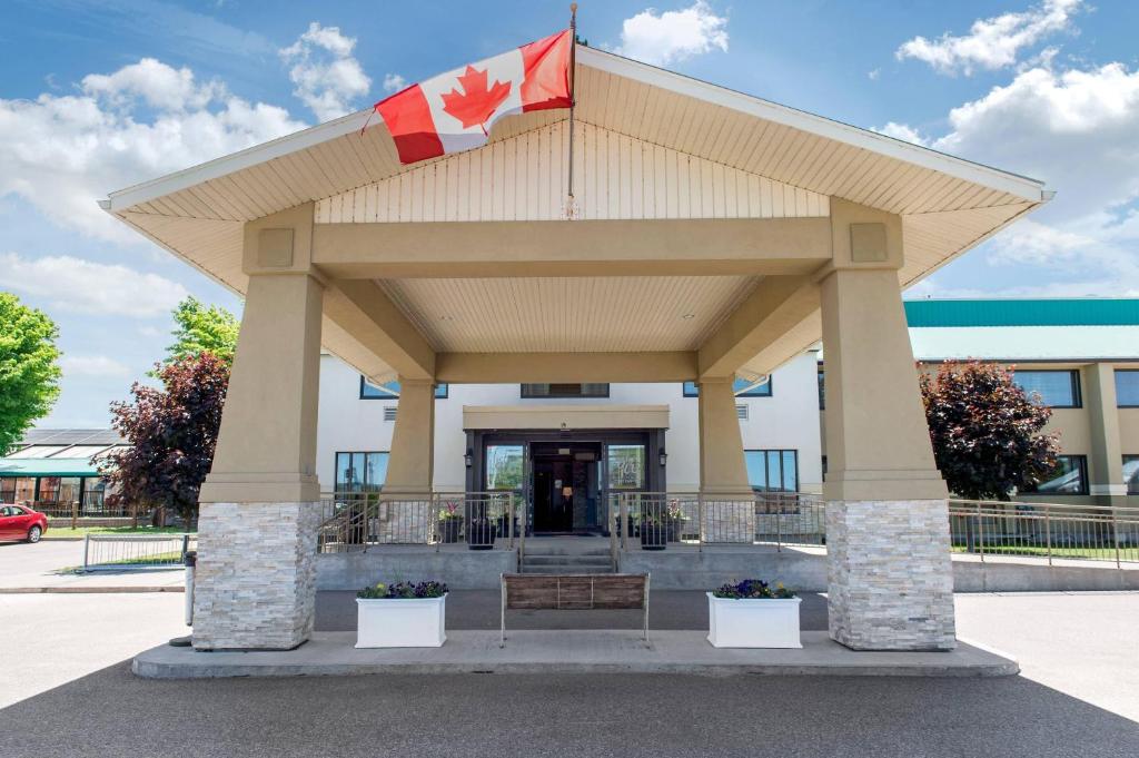 a pavilion with a canadian flag in front of a building at Quality Inn and Conference Centre in Pembroke