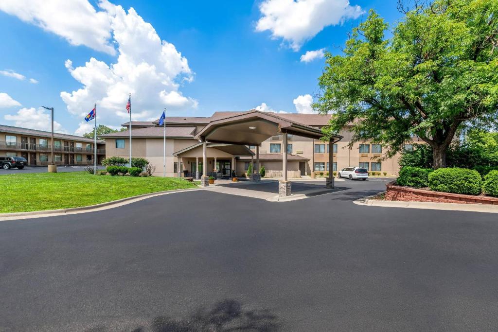 a hotel with a parking lot in front of a building at Quality Inn & Suites Lawrence - University Area in Lawrence