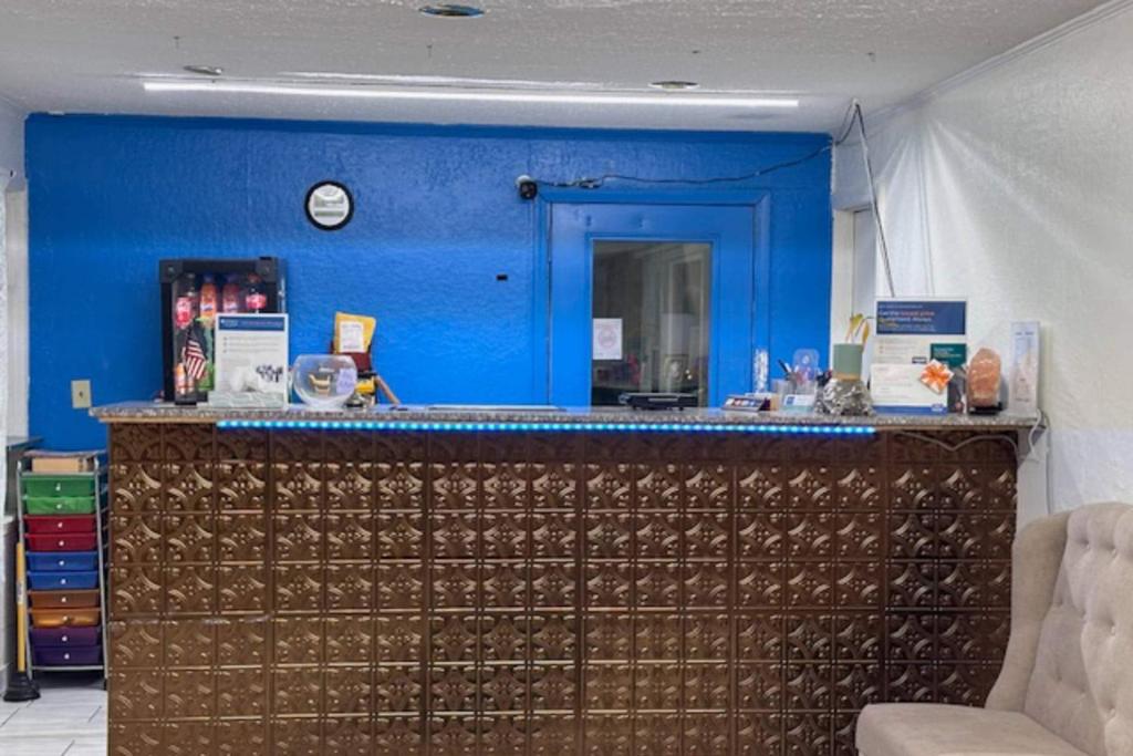 a blue room with a counter with a blue wall at Rodeway Inn Flora in Flora