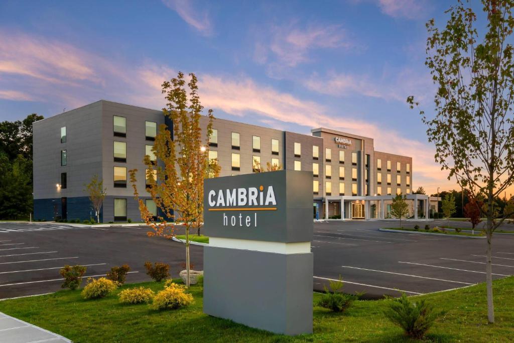 a hotel sign in front of a parking lot at Cambria Hotel & Suites Plymouth in Plymouth