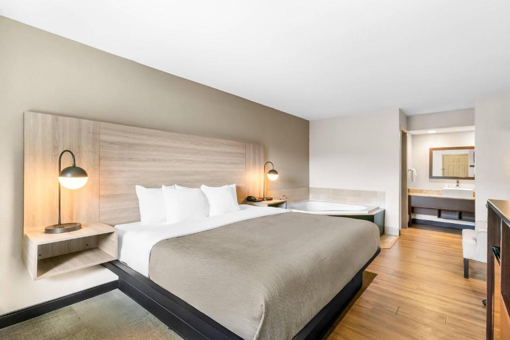 a hotel room with a large bed and a bathroom at Quality Inn in Helen