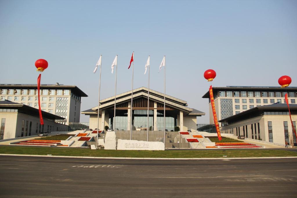 a large building with flags on top of it at Jiangsu Haizhou Bayview Conference Center in Lianyungang