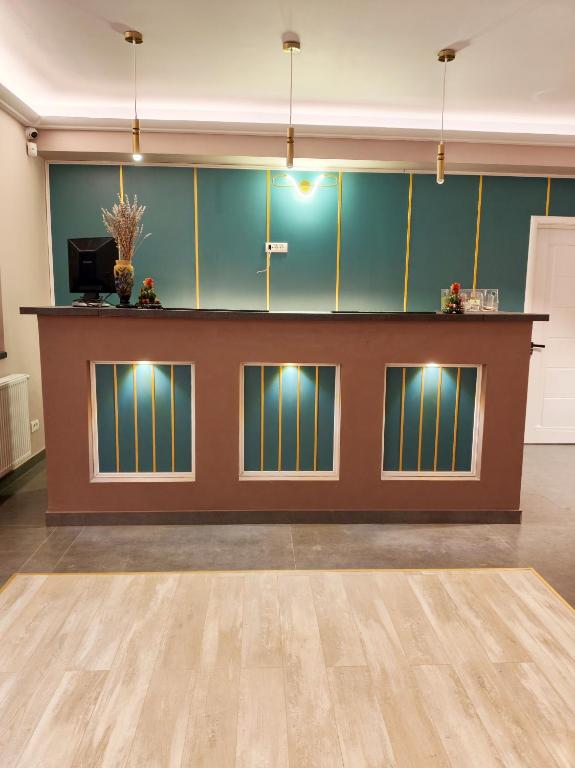 a large room with a counter with lights on it at Otopeni Garden Hotel in Otopeni