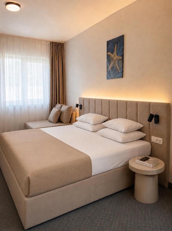 a bedroom with a large bed in a room at Hotel Fineso in Budva