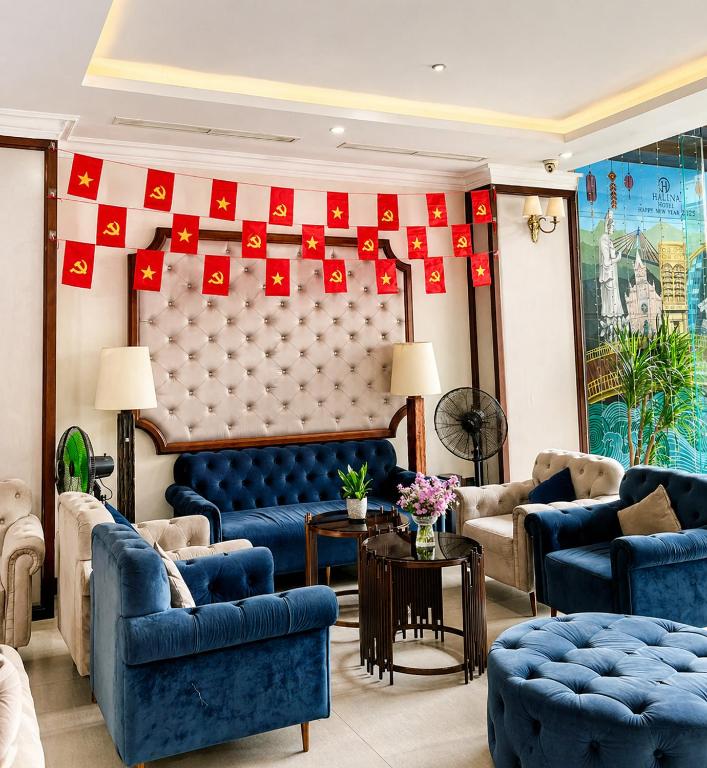 A richly decorated lobby seating area with blue velvet chairs and sofas.