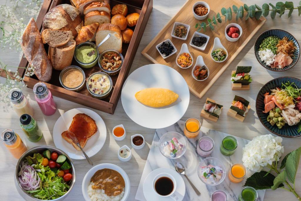 a table with many different plates of food on it at ANA Crowne Plaza Matsuyama by IHG in Matsuyama