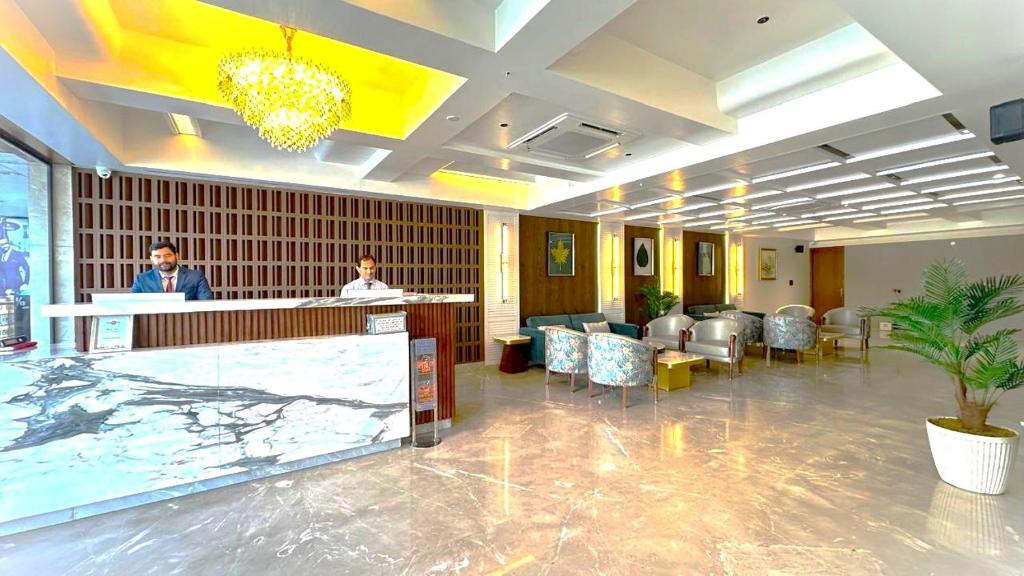 a lobby with a waiting room with people at a counter at Hotel Vintage Zirakpur Chandigarh in Panchkula