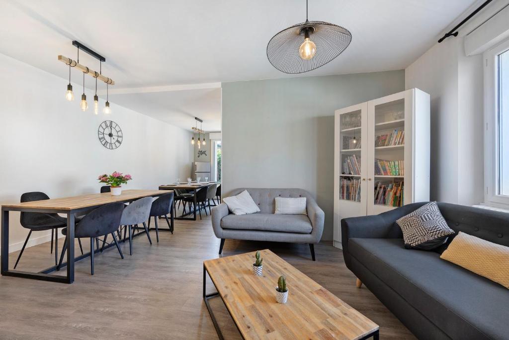 a living room with a couch and a table at Gîte la maison du sabotier in Saint-Malo-du-Bois