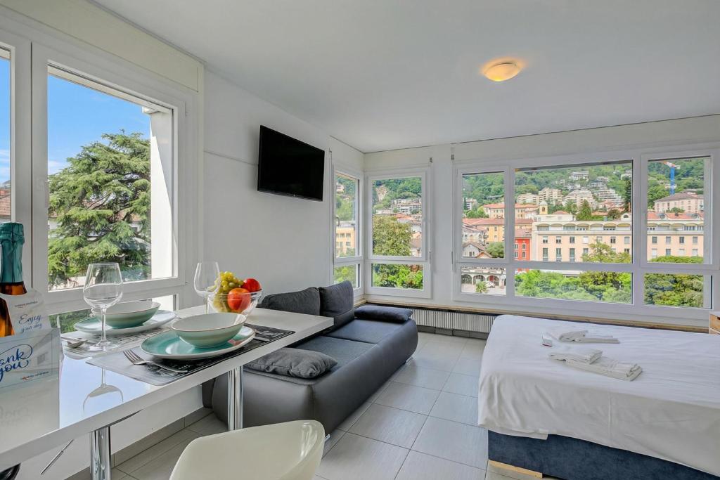 a living room with a couch and a table at Casa Cupido Locarno - Happy Rentals in Locarno