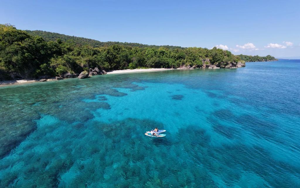a person in a boat in the ocean at Air Wontu in Moyo Island