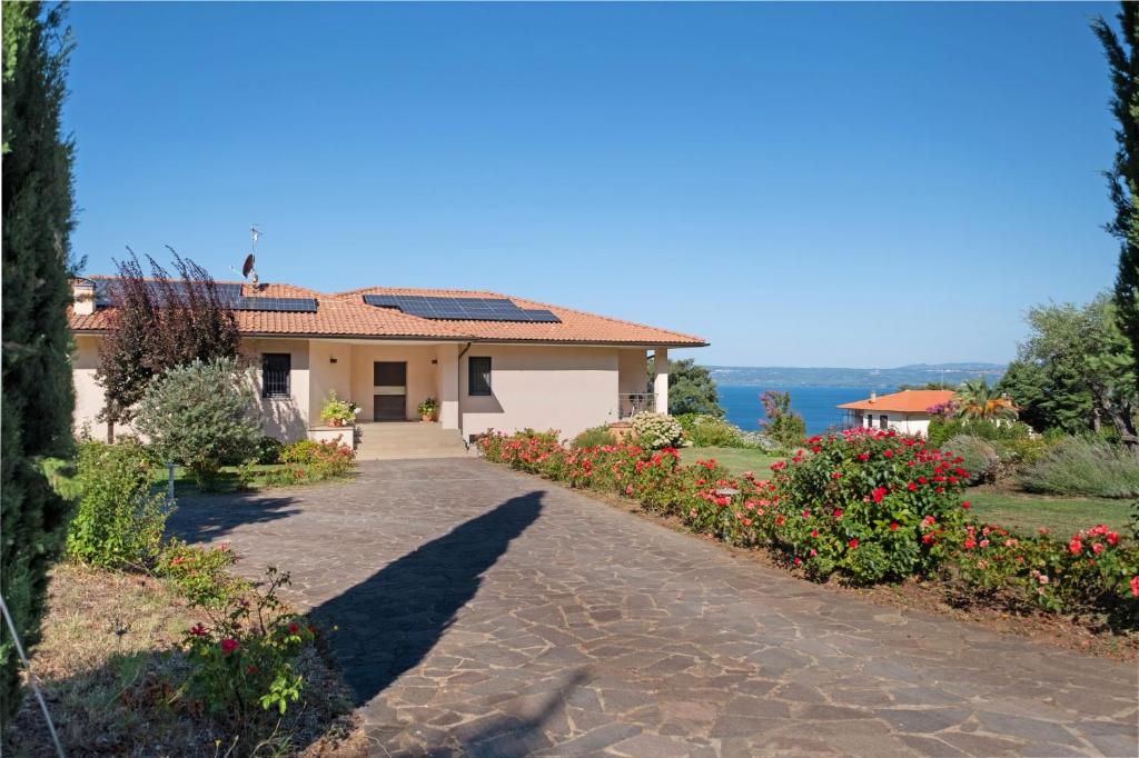 a house with a garden and a driveway at Luxury Apartment Lake View in Bolsena