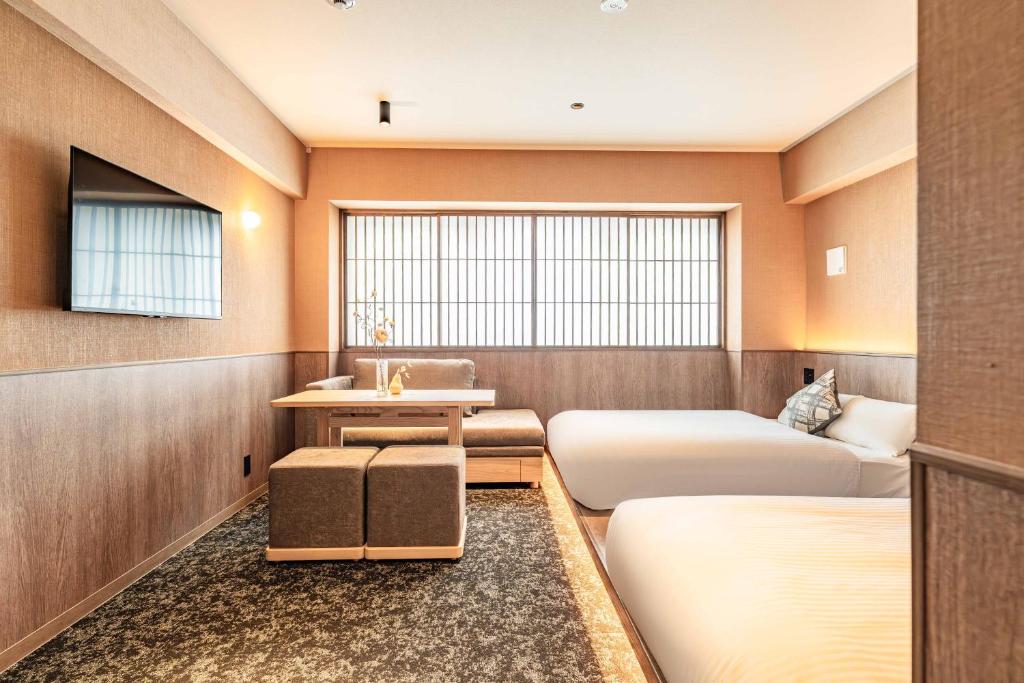 a hotel room with two beds and a sink at Apartment Hotel 11 Gion in Kyoto