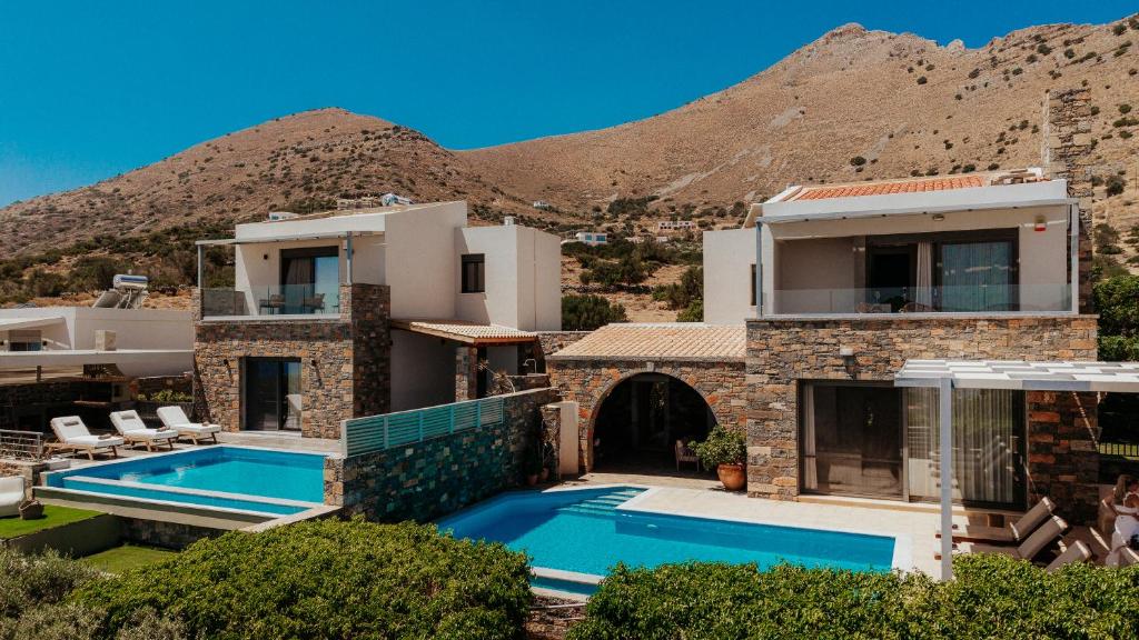 a villa with a swimming pool and a mountain at Apollonia Elounda View Villa in Elounda