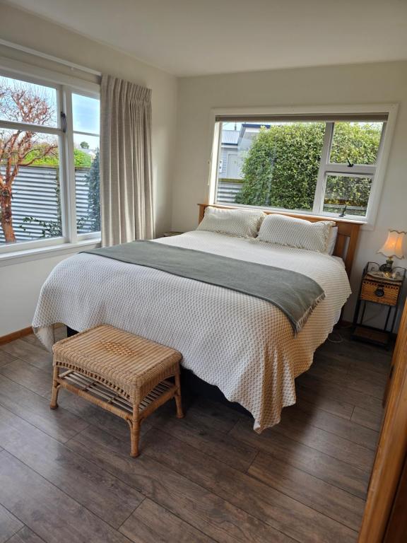 a bedroom with a large bed and two windows at Annie's in Methven