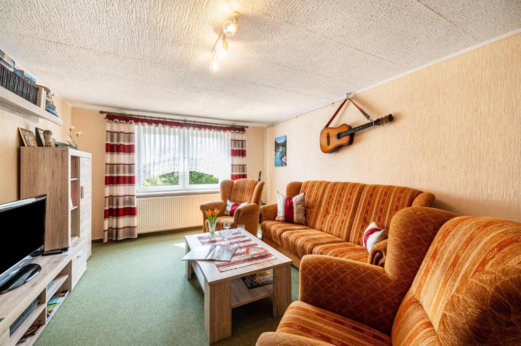 a living room with two couches and a table at Ferienwohnung Stoll in Brüel in Brüel