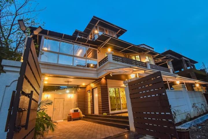 a large house with lights on top of it at Chikku 4 bhk villa in Lonavala