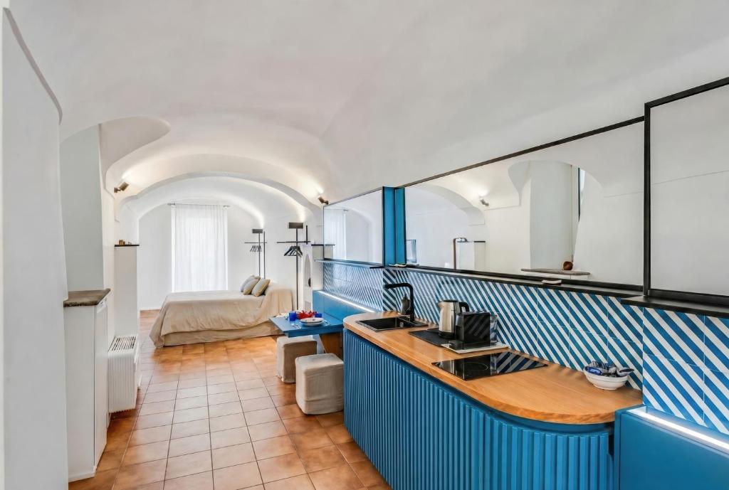a kitchen with blue and white walls and a sink at Starhost - RICORDO DEL CAPITANO, Atrani hidden gem Walking distance from Amalfi & Beach in Atrani