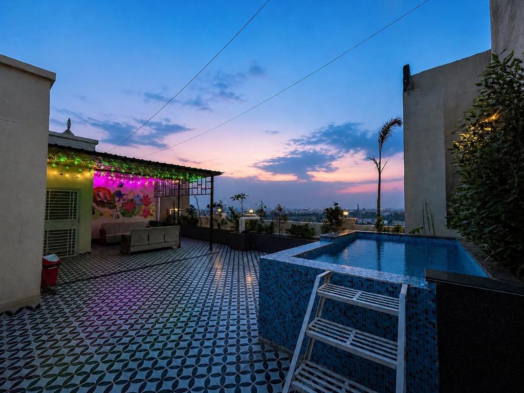 a house with a pool and a chair on a patio at Canvas and Cabana - Cabo in Sonīpat