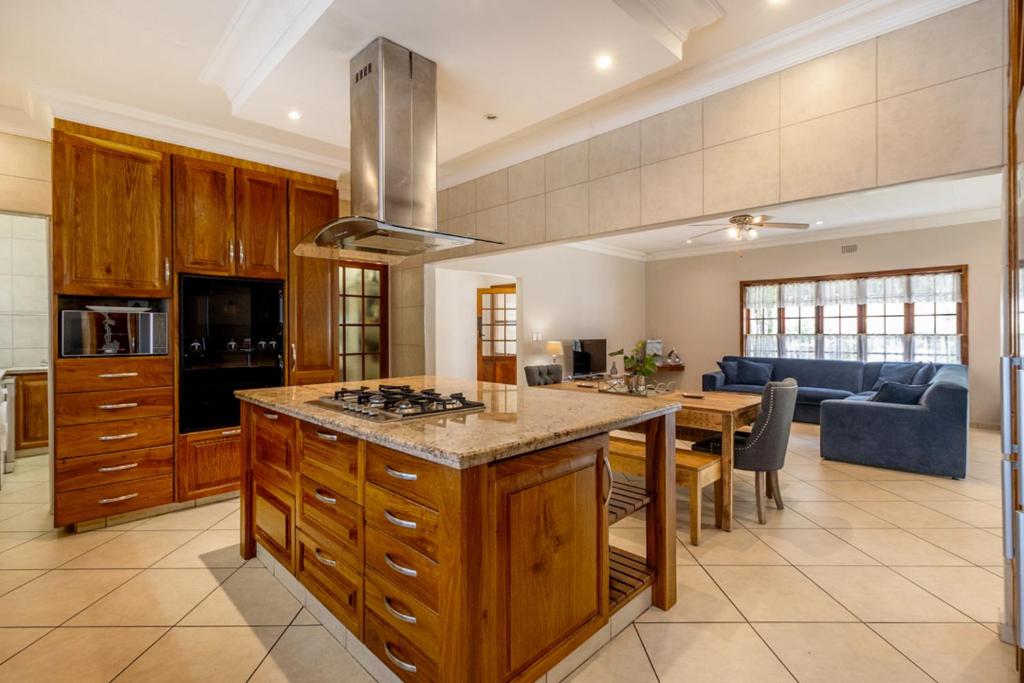 a kitchen with a large island in a room at Comfort on Cabot in Edenvale