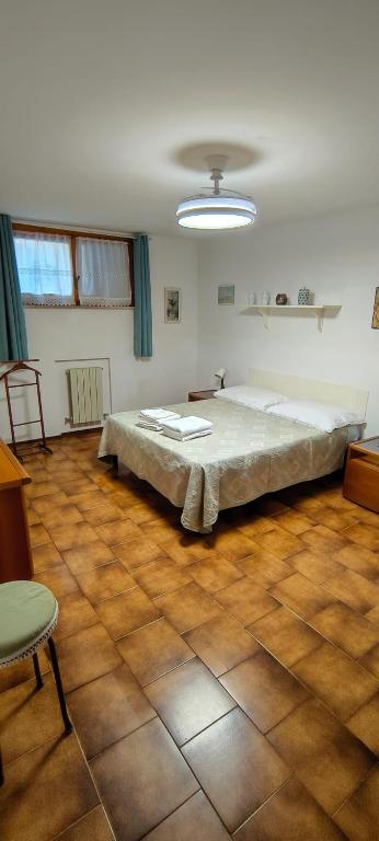 a bedroom with a large bed in a room at Zorel House in Siena