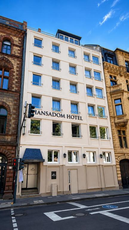 a building with the name of the kensington hotel at Hansadom Hotel Köln Central by Mayburgh in Cologne