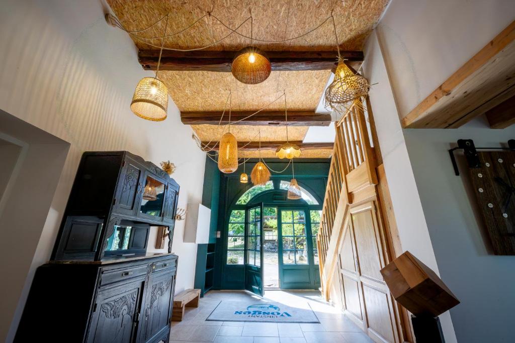 a hallway of a house with a door and some lights at Gîte L'instant Vosges in Aydoilles