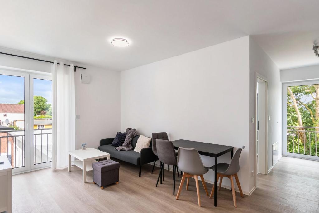 a living room with a table and a couch at Haus Seeluft - W5 in Butjadingen
