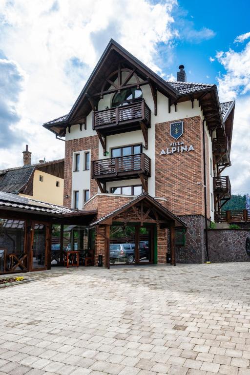 a large building with balconies on top of it at Villa Alpina Borsec in Borsec