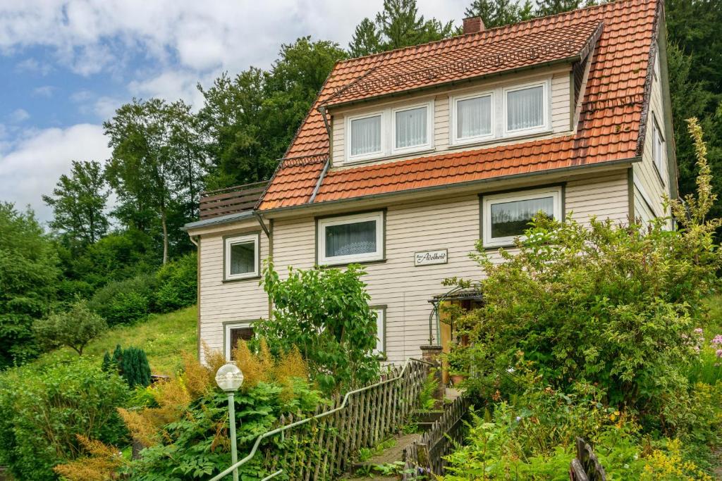 an old house with an orange roof on a hill at Ferienhaus Adelheid in Bad Grund