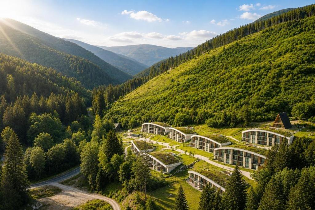 an image of a greenhouse in a hill with trees at Evergreen Tale Apartman F2 in Tale