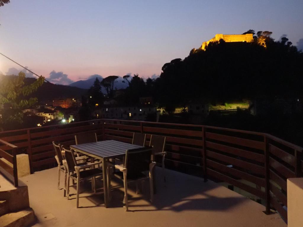 a table and chairs on a balcony at sunset at Nidus in Aulla