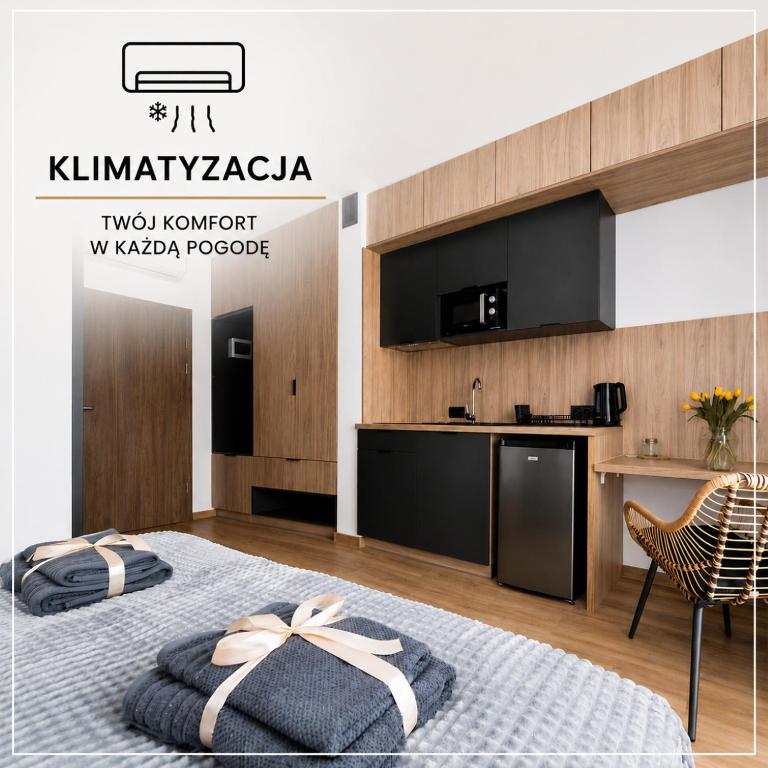 a hotel room with a bed and a kitchen at Apartamenty RIO Skarbimierz-Osiedle in Skarbimierz Osiedle