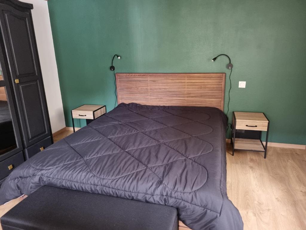 a bedroom with a bed and two night stands at pas de nom in Rosenwiller