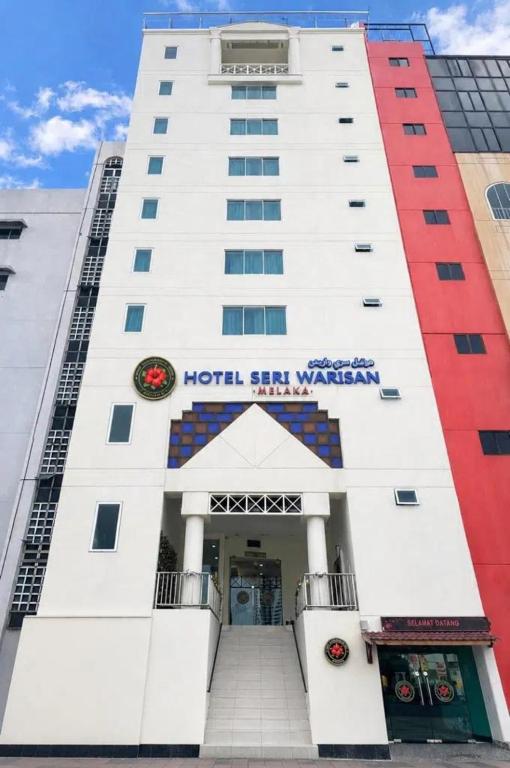 a hotel with a sign on the front of a building at Hotel Seri Warisan Melaka in Malacca