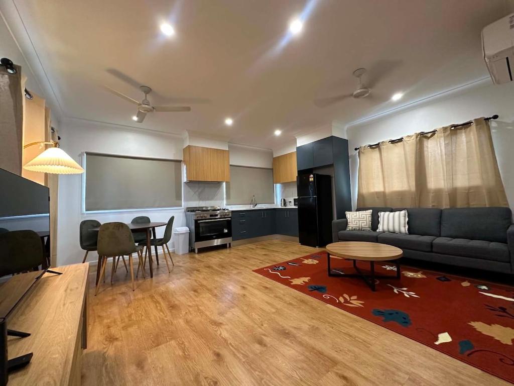 a living room with a couch and a table at Nest & Rest in Westcourt