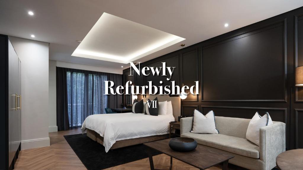 a bedroom with a bed and a couch at Seven Villa Hotel & Spa in Johannesburg